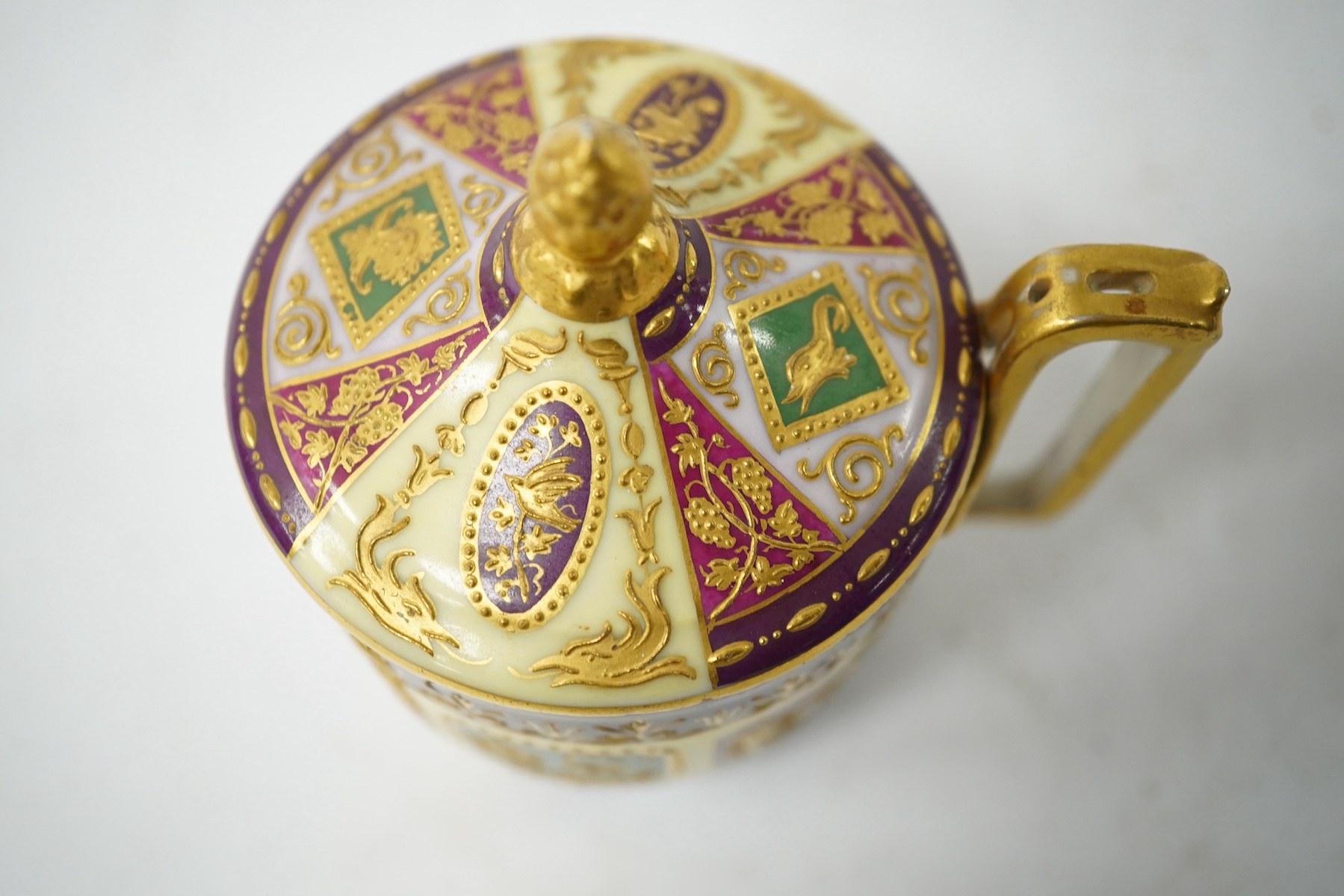 A late 19th century Vienna custard cup and saucer, outside and later decorated, beehive mark, 10cm high. Condition - good